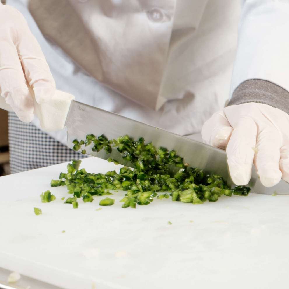 Job Corps student chopping green onions