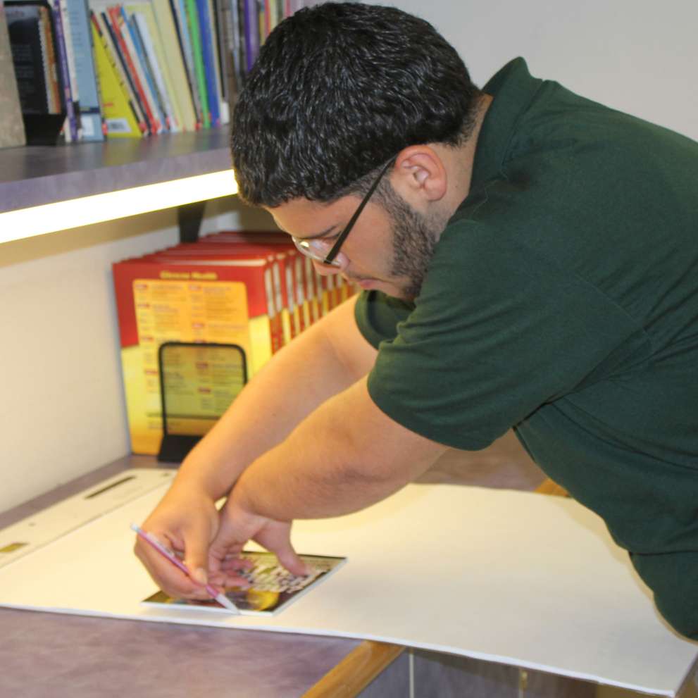 Careers Page Sign, Billboard, and Display Background Image A Sign, Billboard, and Display worker installs a sign in a hallway