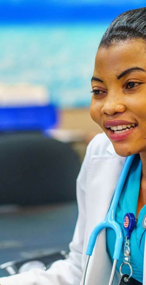 A clinical medical assistant listens to a patient.