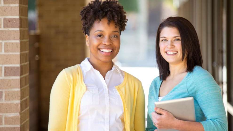 For Citizens Program Administration Page Image Two smiling students pose for a photo between classes