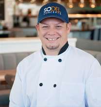 Charles Armstrong, Job Corps graduate, wearing a chef coat