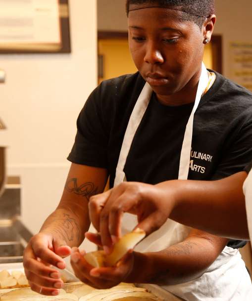 Culinary Arts students cut potatoes