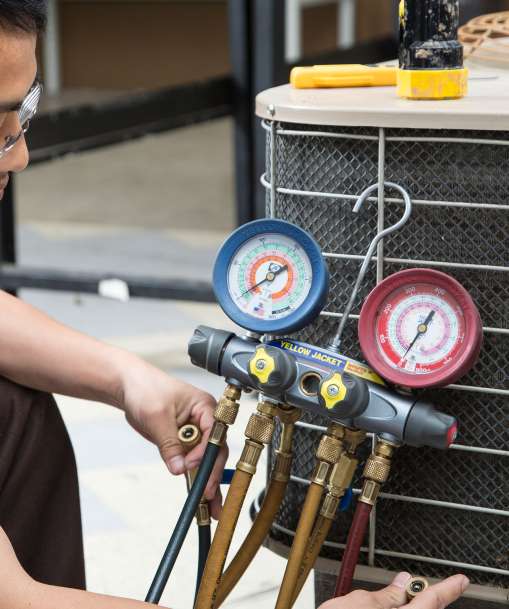 HVAC student working on a air conditioner