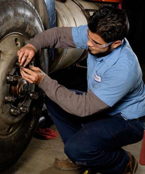 Job Corps student working on large tire