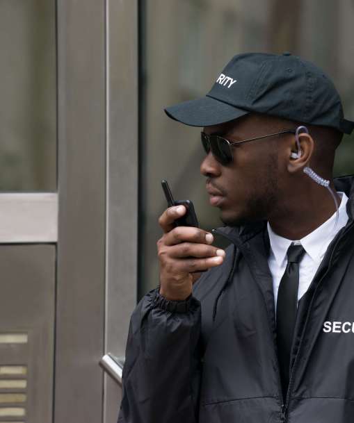 Security guard speaking into a radio
