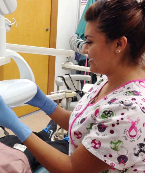 A Dental Assistant takes an X-ray. 