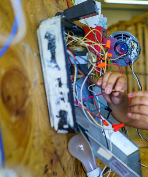 An electrician checks wiring
