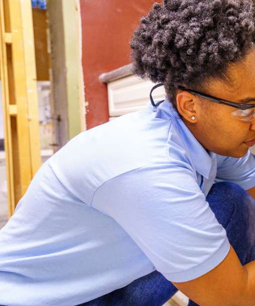 A Job Corps student performs a plumbing repair