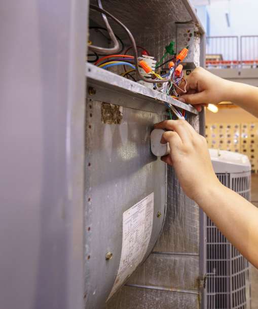 A Stationary Engineer works on equipment in an industrial setting.