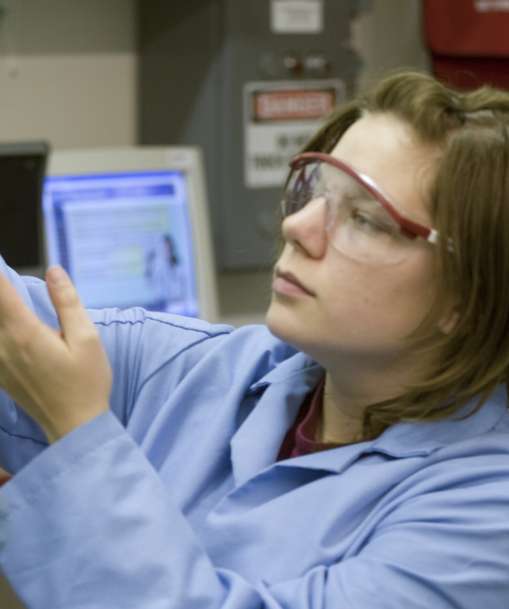 A wastewater nanagement student holds a water sample
