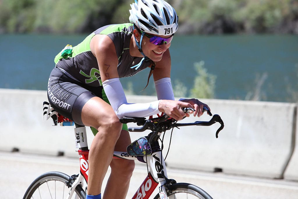 Montana Multisport Triathlon: Milica McDowell Ironman 70.3 Boise on a bike in a Montana Multisport tri kit
