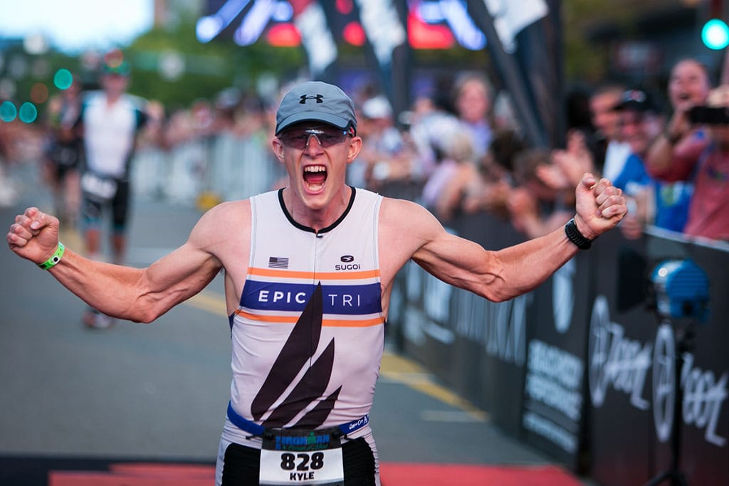 Male wearing an Epic Tri jersey finishing Ironman Coeur d'Alene