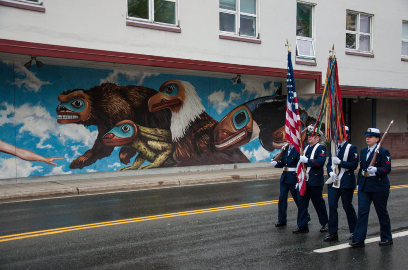 The color guard marches past City Hall