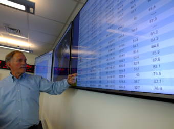 Ed Page, executive director of Marine Exchange of Alaska, checks the latest marine and weather information from around the region.