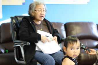 Evelyn Yanez points to pictures and says the Yup'ik name of the animal, object or activity, during a Yup'ik immersion program for infants to 5-year-olds in the village of Igiugig. (Photo by Avery Lill/KDLG)