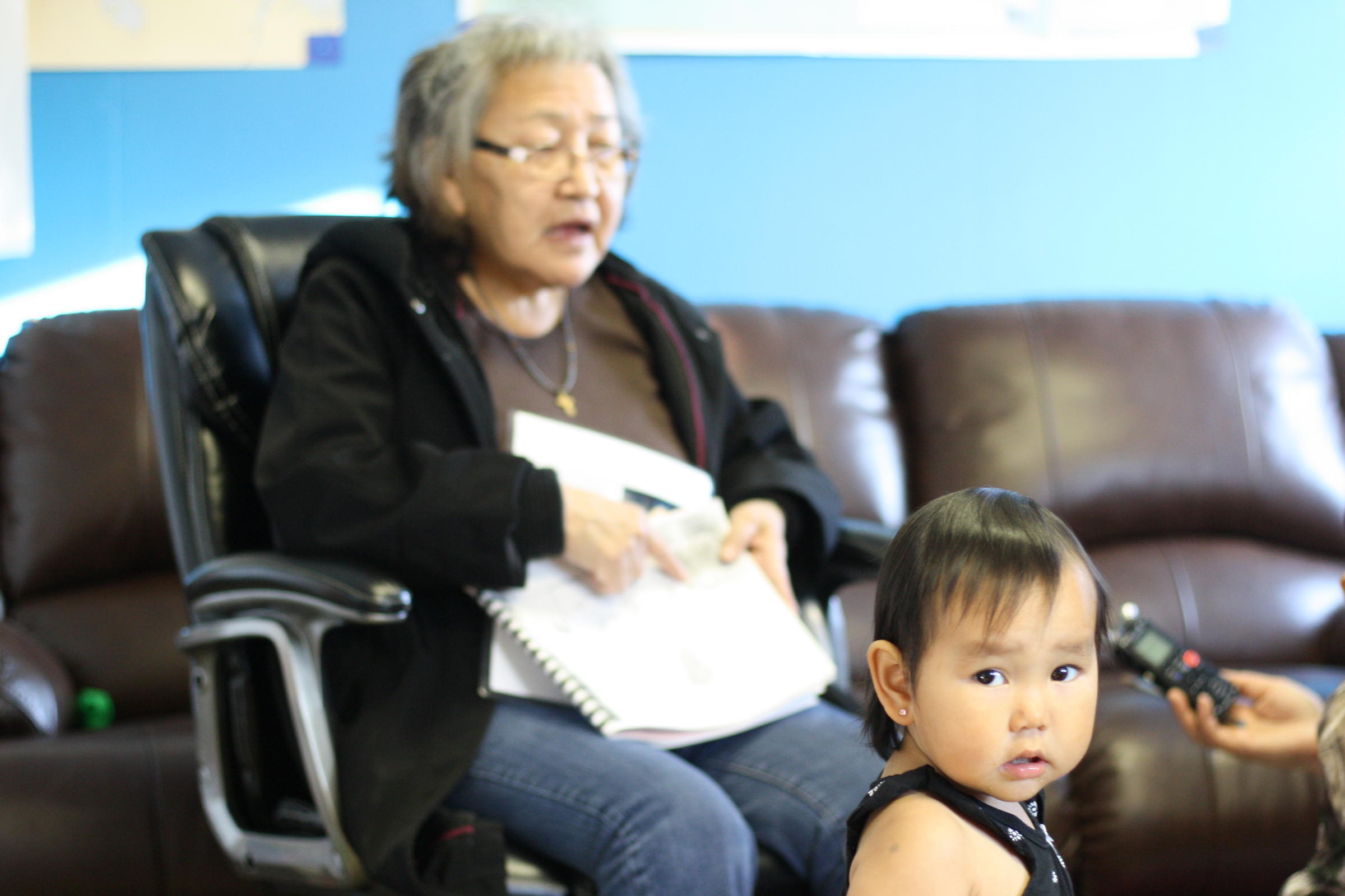 Evelyn Yanez points to pictures and says the Yup'ik name of the animal, object or activity, during a Yup'ik immersion program for infants to 5-year-olds in the village of Igiugig. (Photo by Avery Lill/KDLG)