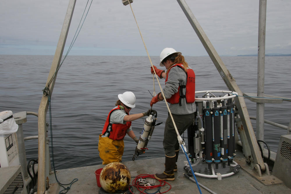Olympic Coast National Marine Sanctuary research team members, Kathy Hough and LTJG Alisha Friel, recover sensors deployed seasonally off the coast of Washington from the research vessel Tatoosh in July 2017. (Photo courtesy S. Maenner/NOAA)