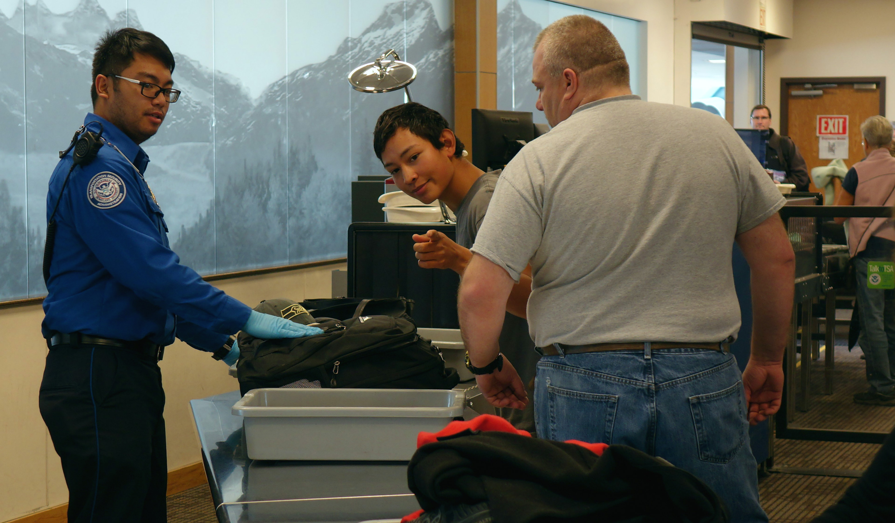 transportation security officer renier cava preps passengers carry on belongings for x ray - Transportation Security Officer transportation security officer renier cava preps passengers carry on belongings for x ray - Transportation Security Officer