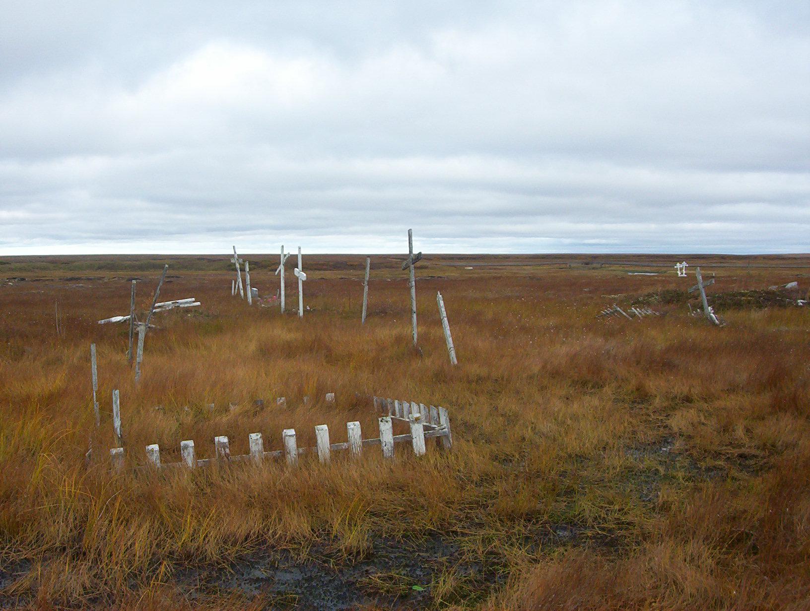 As the permafrost thaws, Kongiganak's cemetery is turning into swampland. Community members are now laying their loved ones to rest on raised platforms above ground. (Photo Teresa Cotsirilos/KYUK)