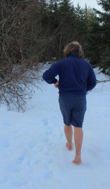Ezra Strong hikes barefoot along the Dredge Lake Trail in Juneau. (Photo by Adelyn Baxter/KTOO)