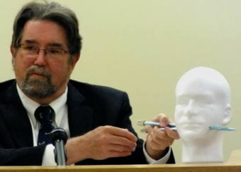 Dr. Todd Grey uses a Styrofoam model with knitting needles to demonstrate how two bullets may have passed through Tony Rosales. Grey testified May 7, 2018 during the Mark DeSimone homicide trial in Juneau Superior Court.