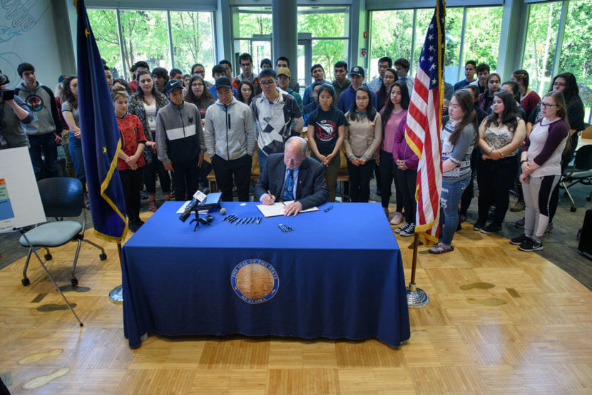 Gov. Bill Walker signs Senate Bill 26, House Bill 286, House Bill 285, and Senate Bill 142 in the ANSEP building on the UAA campus in Anchorage, on June 13, 2018. The suite of bills cover permanent fund draws and the operating, mental health and capital budgets for fiscal year 2019.