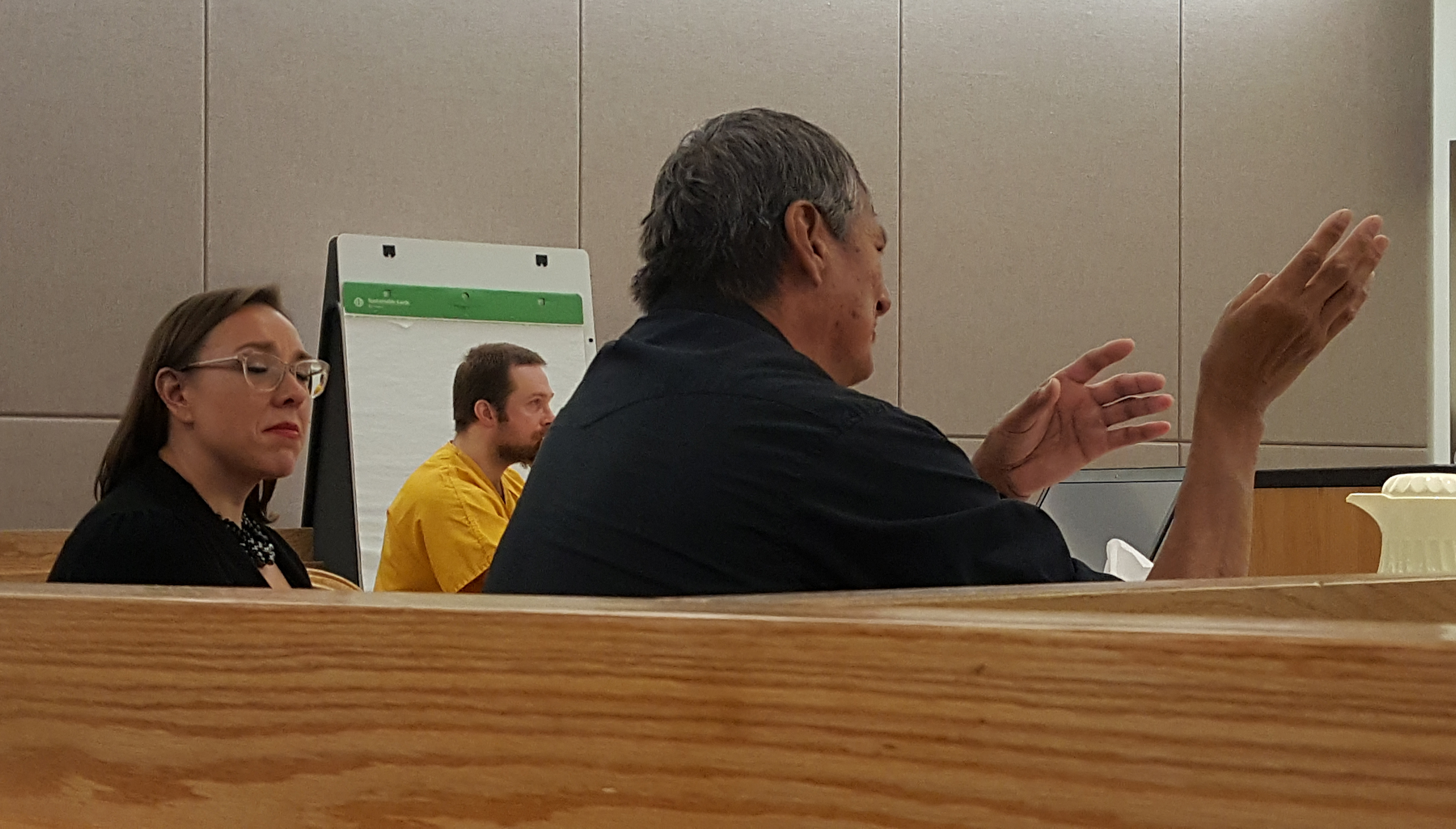 Assistant District Attorney Amy Paige listens as murder victim Brandon Cook's father, Donald Cook, speaks during the sentencing hearing for Christopher Strawn, who was convicted in the 2015 death of Brandon Cook. (Photo by Tripp J Crouse/KTOO)