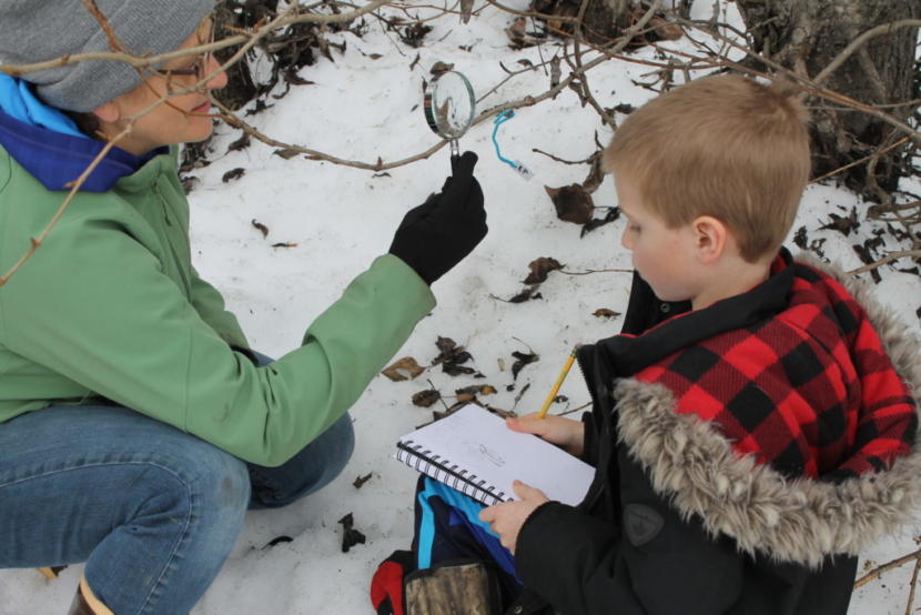 Justina Hotch helps a student examine a bud. (Photo by Henry Leasia/KHNS)