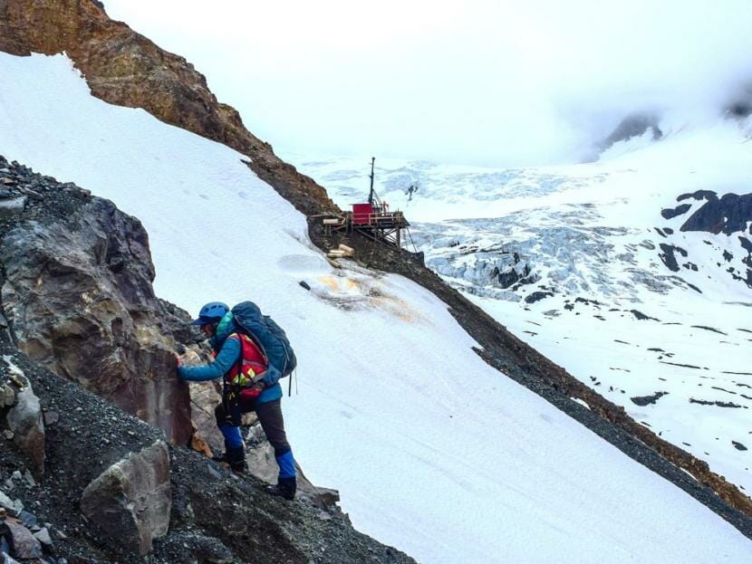 A Constantine Metal Resources employee examines an area near the Palmer Project site.