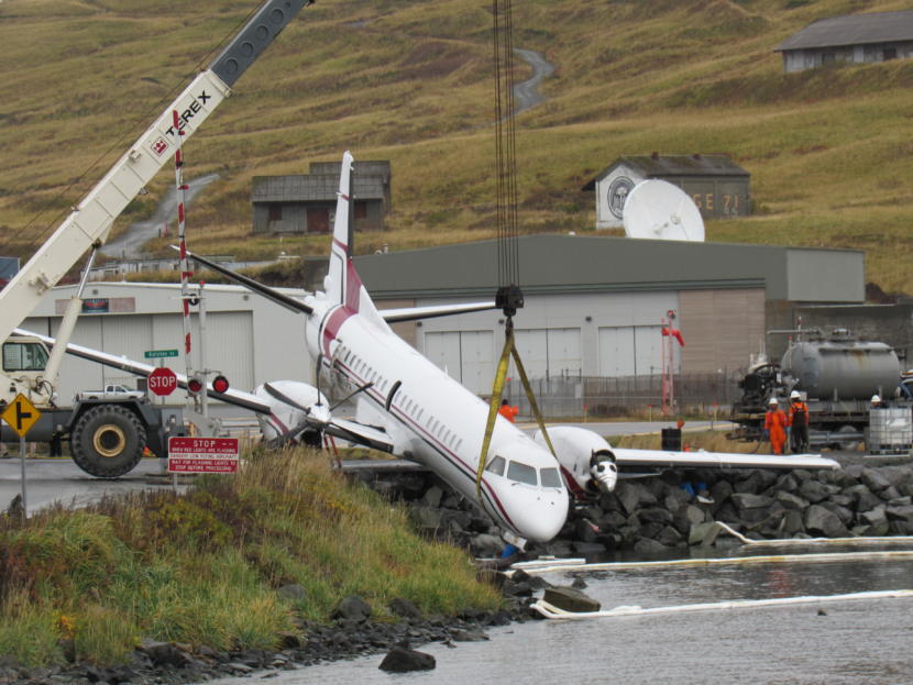 A crane hoists PenAir’s Saab 2000 airplane on Oct. 18, 2019. One person was killed and multiple people were injured when the plane went off the runway while attempting to land the evening before.