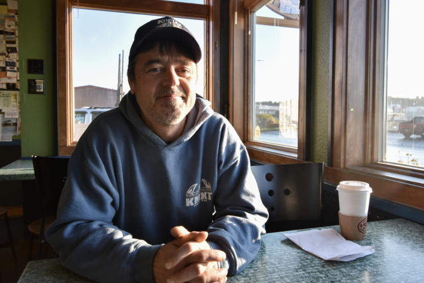 Darius Kasprzak, a jig fisherman, sits down for coffee near the Kodiak harbor. (Photo by Kavitha George/Alaska’s Energy Desk)