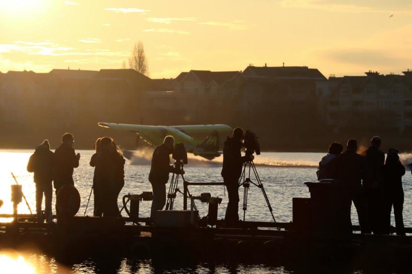 Media follow an electric seaplane's first landing on Dec. 10, 2019, at the company's seaplane base on the south side of Vancouver International Airport.