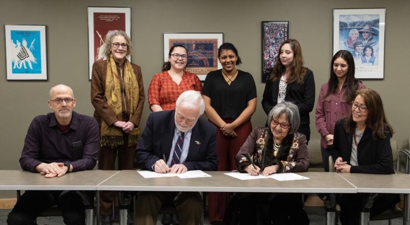 University of Alaska Southeast Chancellor Rick Caulfield and Sealaska Heritage Institute President Rosita Worl sign an agreement establishing a scholarship program to train 16 scholars in Native languages on March 4, 2020, at Sealaska Heritage Institute.