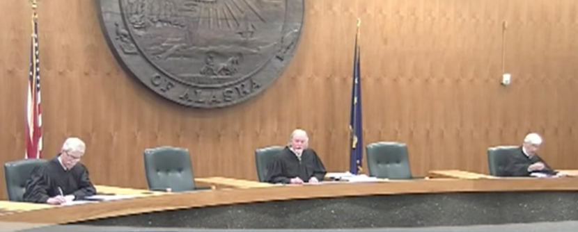 Justices Peter Maassen and Craig Stowers and retired Justice Robert Eastaugh listen to oral arguments in the case of State Division of Elections v. Recall Dunleavy. Justices Daniel Winfree and Susan Carney participated by phone, as did the lawyers. Chief Justice Joel Bolger recused himself. (Screenshot from 360 North)