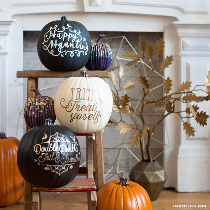 Halloween vinyl decals on pumpkins in front of fireplace