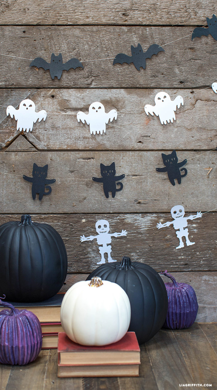 Halloween garland of papercut bats, ghosts, cats, and skeletons