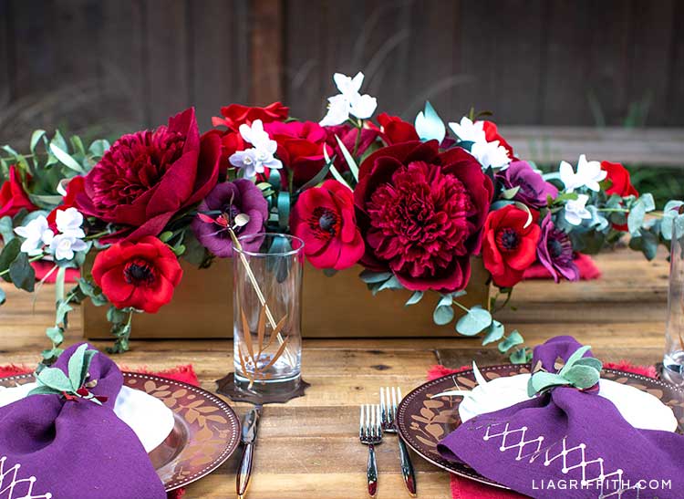 crepe paper red charm peony in floral centerpiece on holiday table with DIY place settings