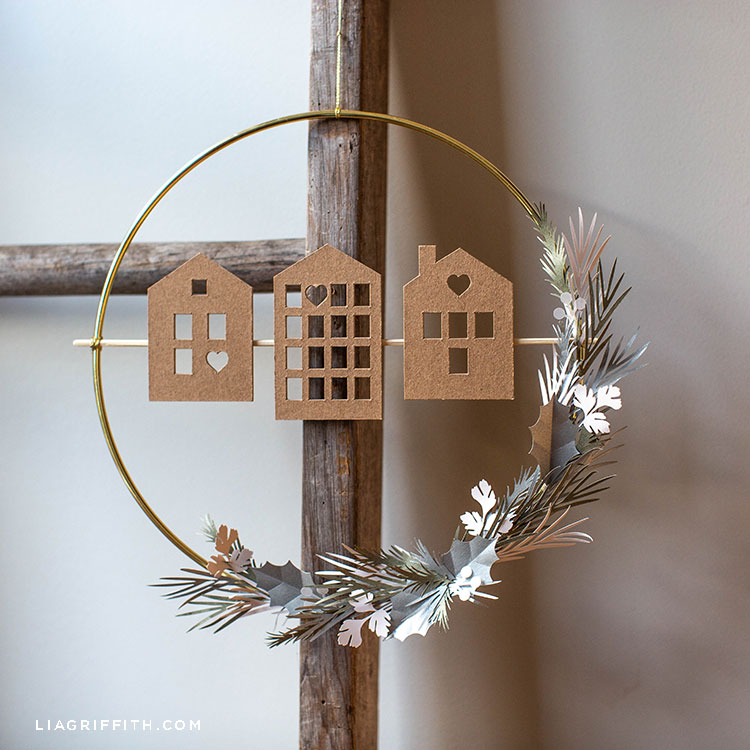 DIY Scandi house and greenery wreath hanging on wooden ladder