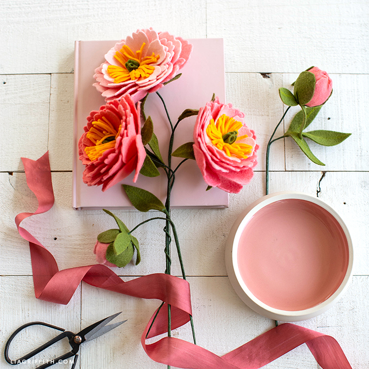 felt coral charm peony flowers and buds with pink book, pink ribbon, and pink bowl