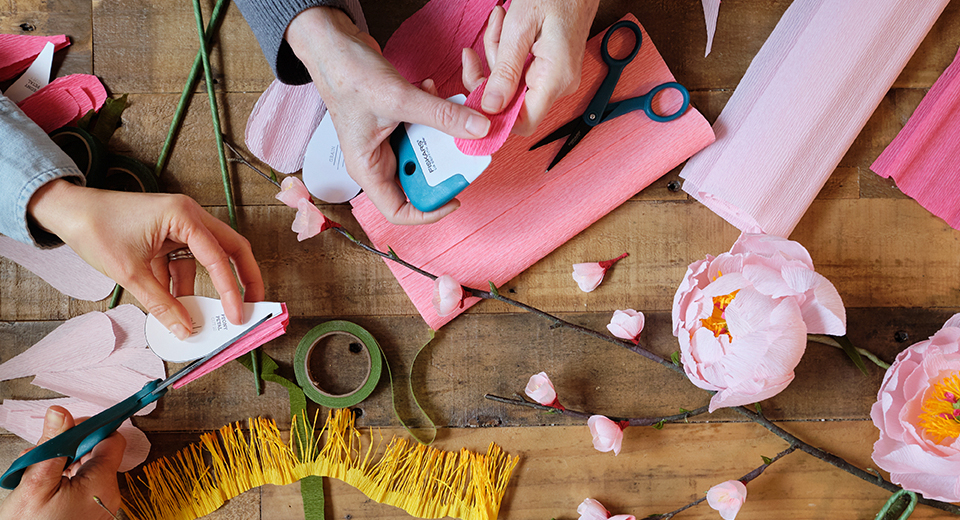 Lia and Anna crafting paper flowers.