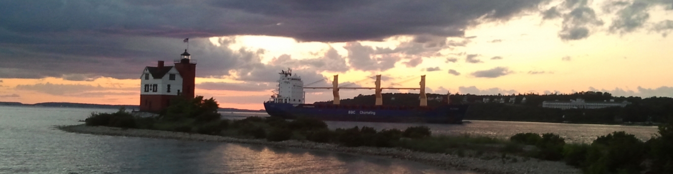Round Island Lighthouse with passing freighter through the channel.