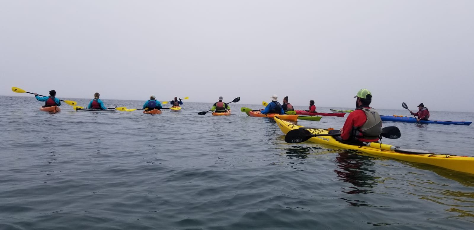A Great Turtle Kayak Tours group paddling out on the water off Mackinac Island