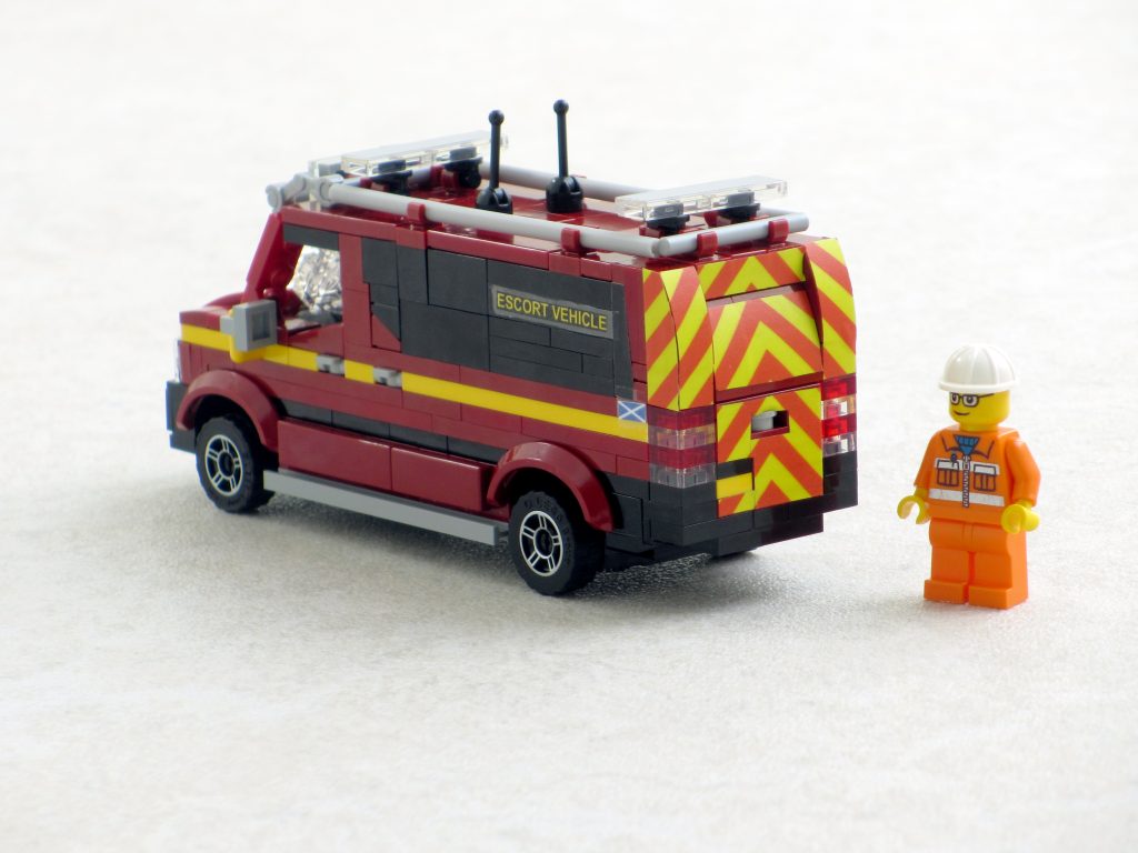 A Lego model of a Mercedes Sprinter van with chevron markings