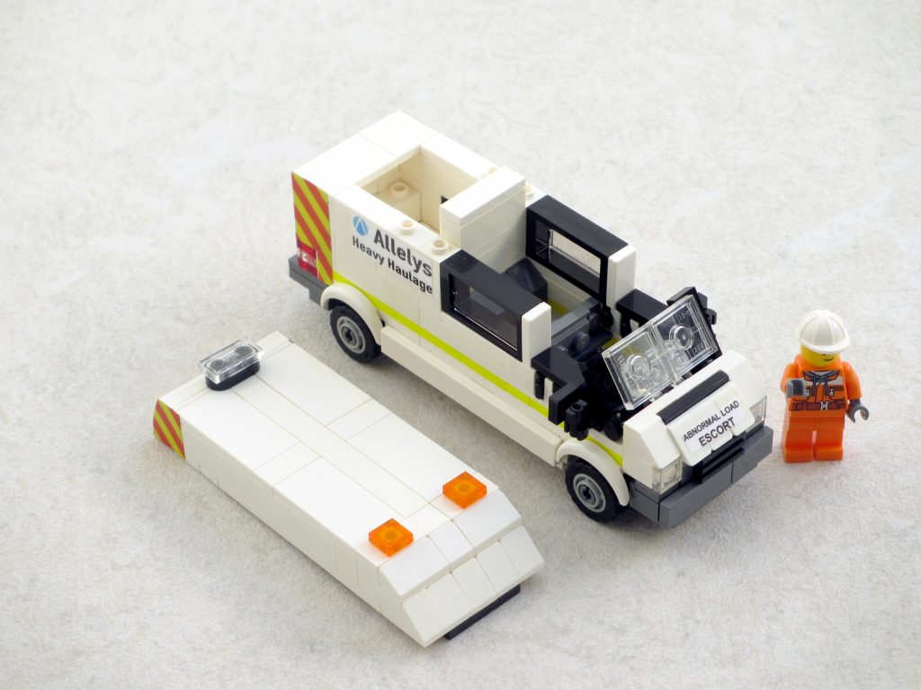 A Lego model of a Ford Transit with its roof removed