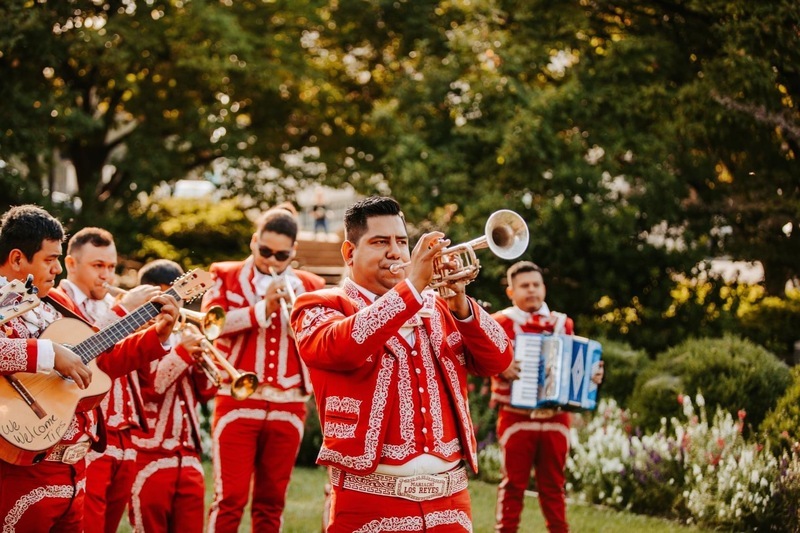 Fiesta Mariachi ensemble performing in traditional traje