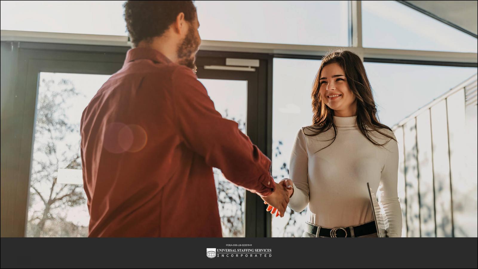 A person shaking hands with a company representative