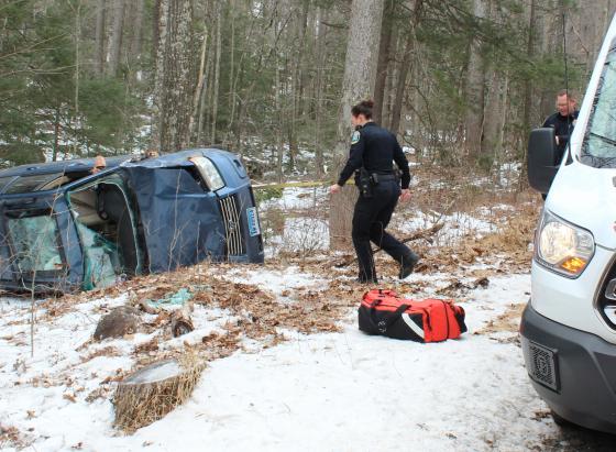 A Newtown police officer walks toward a Subaru Forester that went off Great Quarter Road and struck a tree before rolling onto its passenger side around 10:15 am, Wednesday, February 20. An unidentified male driver had reportedly been traveling west when he lost control of his vehicle just west of Andras Road. Newtown Volunteer Ambulance Corps and Sandy Hook Volunteer Fire & Rescue firefighters also responded to the accident, which closed the roadway for a short time. The driver was checked for injuries but