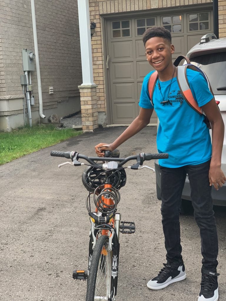 Canada for Kids: Cameron with his bike on his way to school
