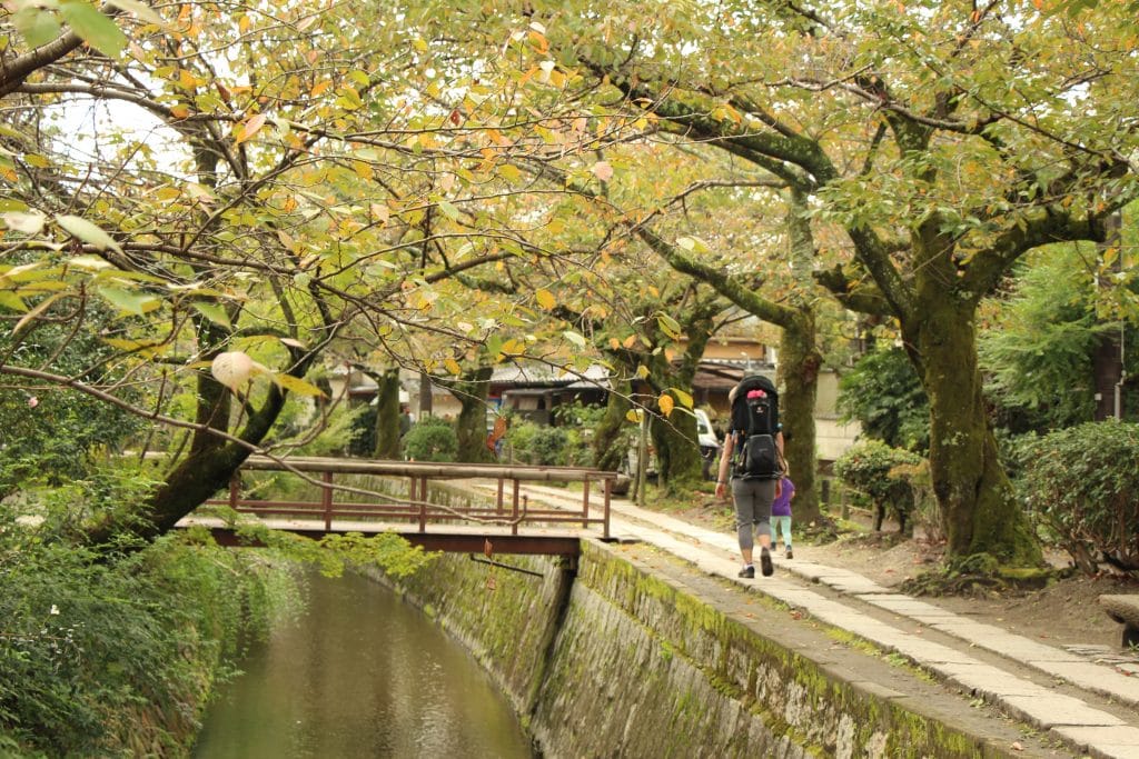 Kyoto Day Trip: Family walking stone-paved pathway of The Philosopher's Path in Kyoto, Japan.