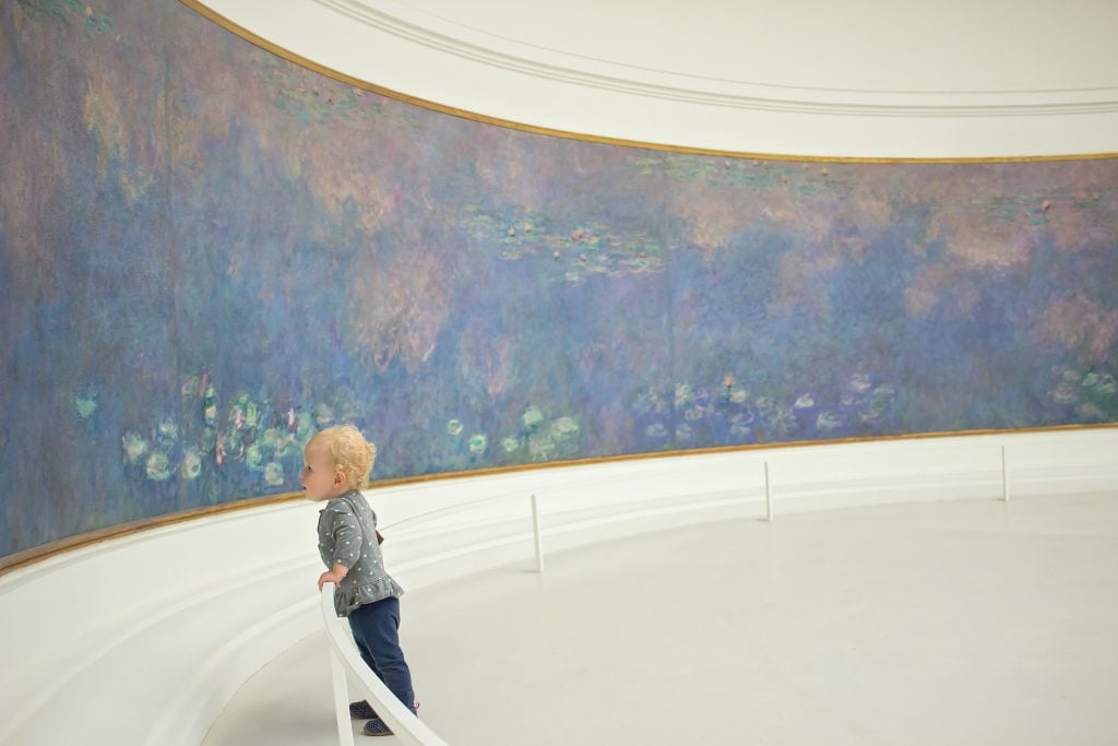 Paris with kids: A child viewing painting at Musée de l'Orangerie